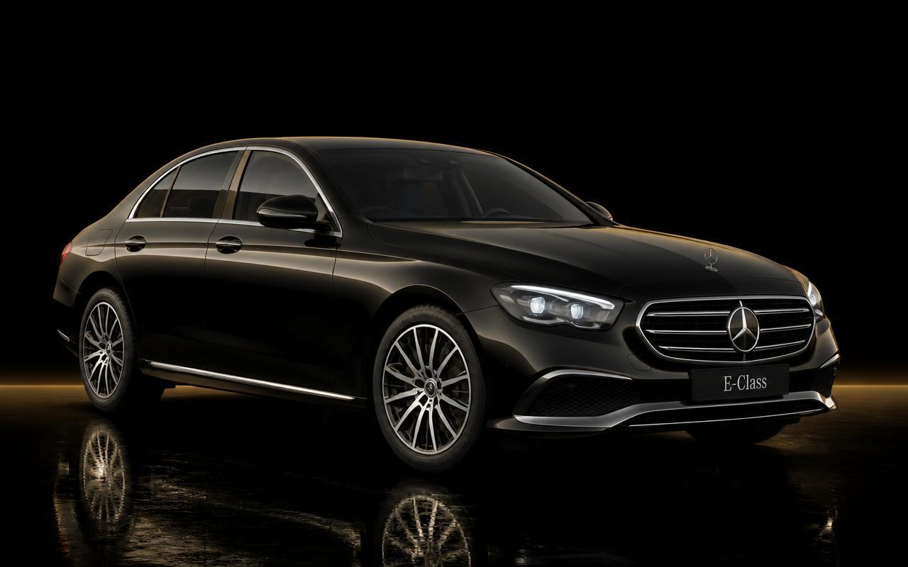 Black Mercedes-Benz E-Class business sedan on a dark studio background